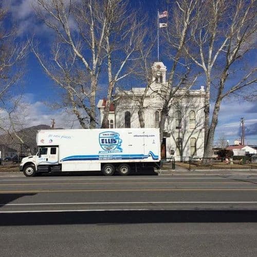 Truck parked in front of a historic building.