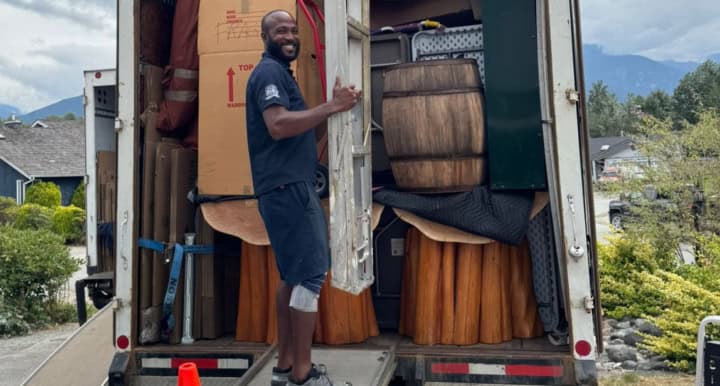 Man loading moving truck with furniture