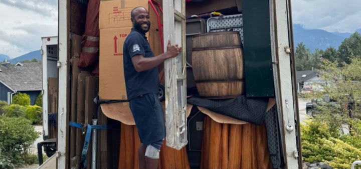 Person loading moving truck outdoors