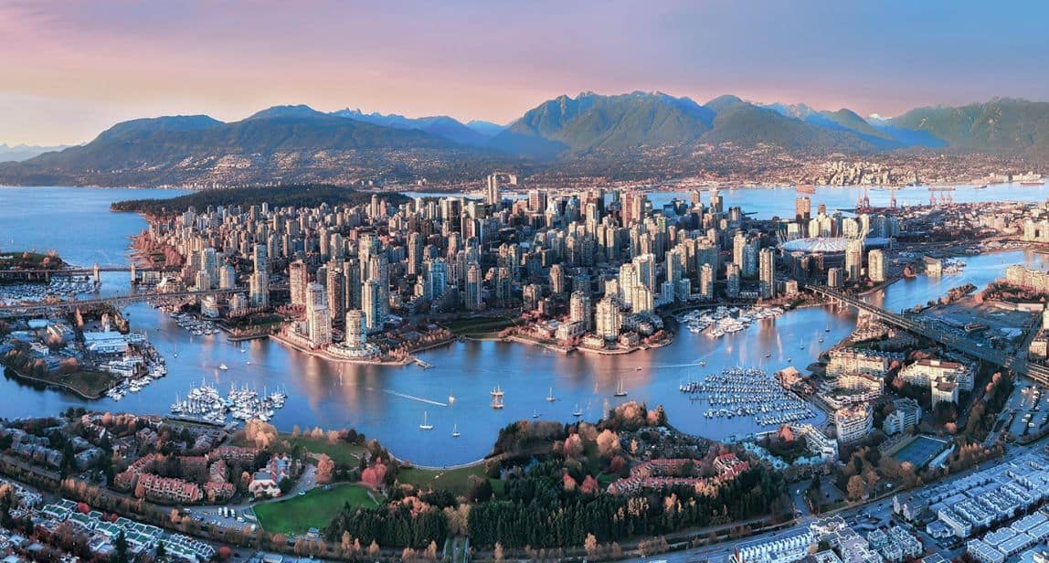 Aerial view of Vancouver cityscape and mountains.